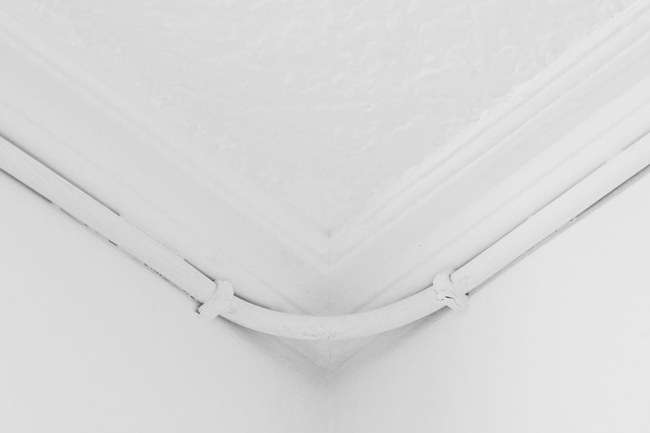 Water damage restoration Oxnard CA: Close up of the corner of the ceiling