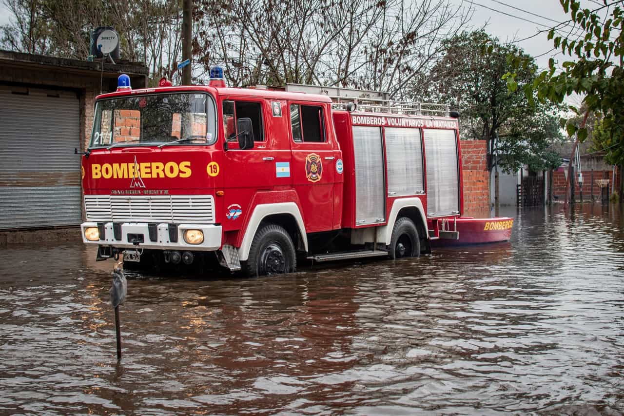 Water damage restoration Riverside CA: Fire truck navigating flooded streets
