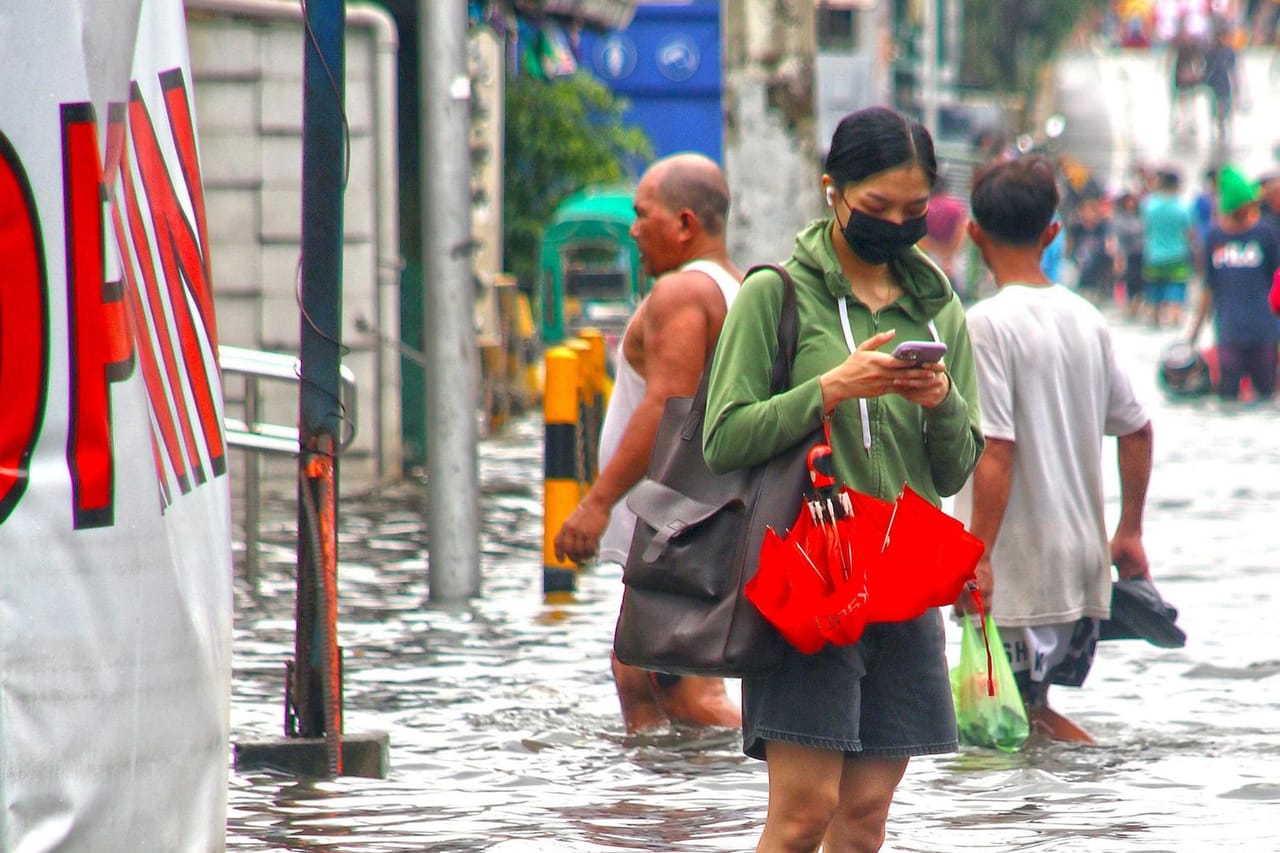 Water damage restoration San Angelo TX: Flooded street with people walking