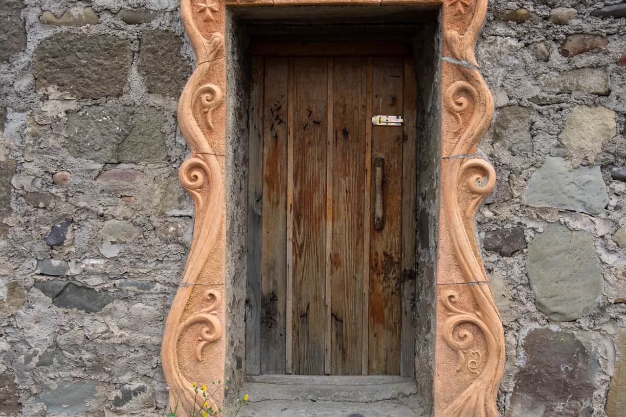 Water damage restoration Santa Ana CA: Wooden door on concrete wall
