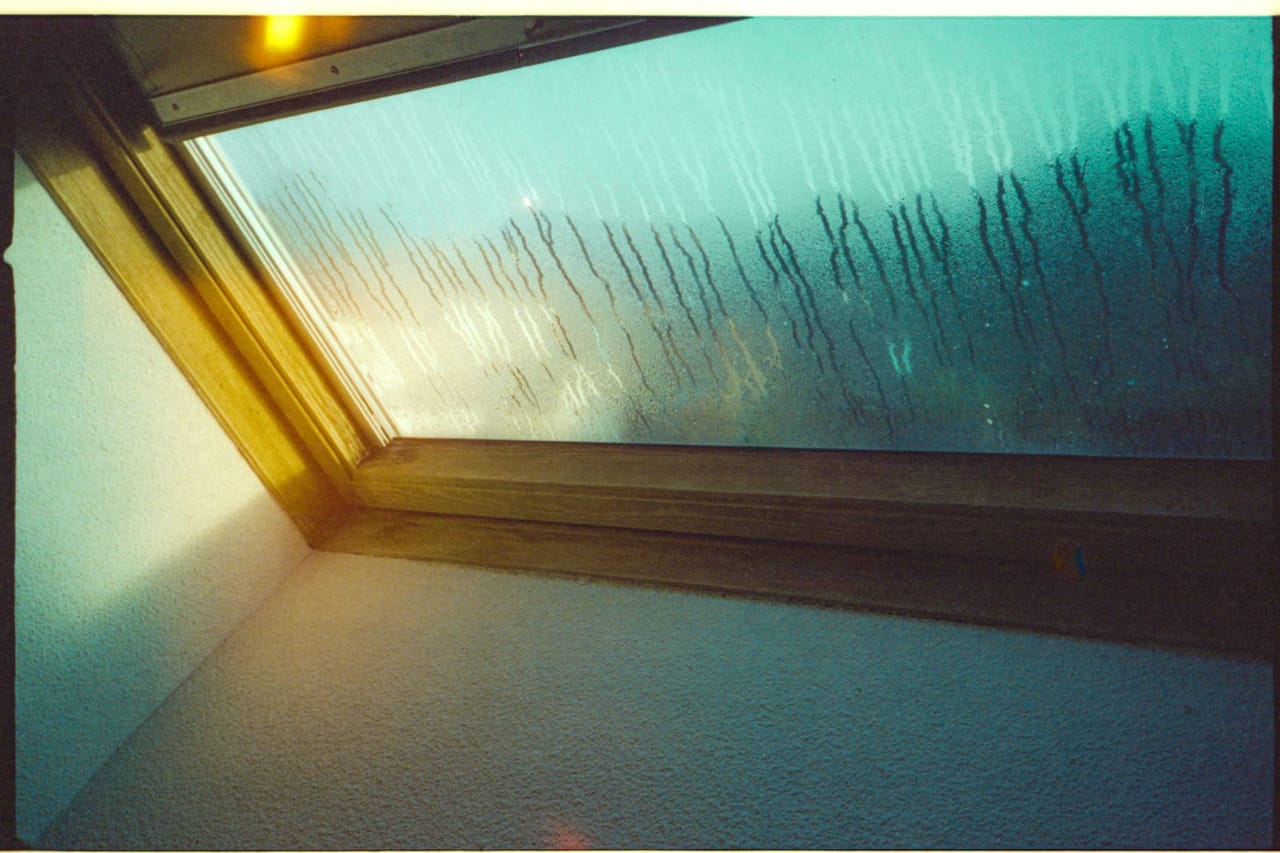 Water damage restoration Santa Rosa CA: Mist on the glass window with wooden frame