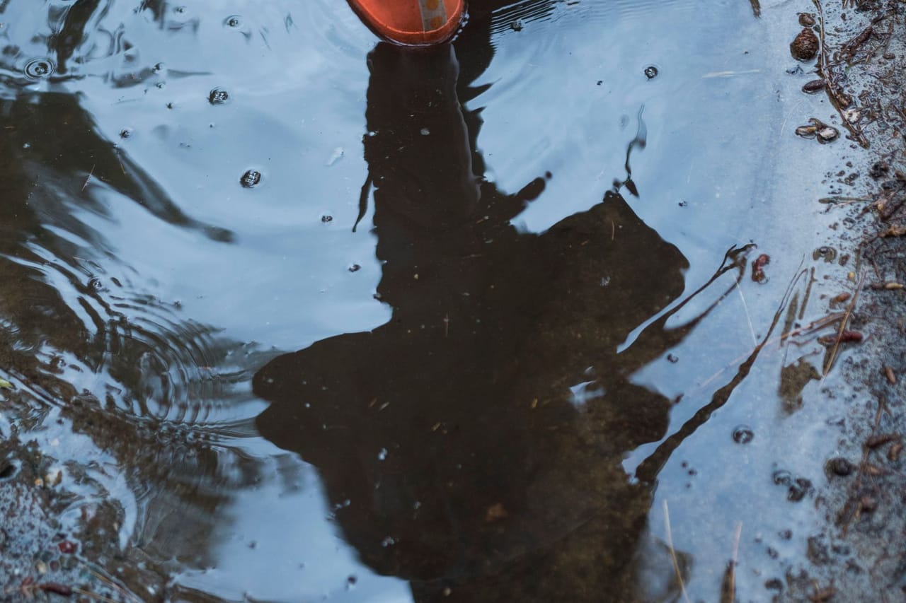 Water damage restoration Tacoma WA: Person standing on puddle