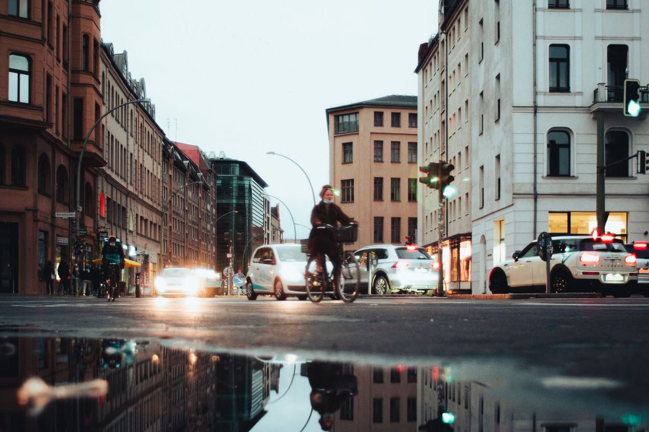 Water damage restoration Texas City TX: A puddle on the road reflecting buildings in a city