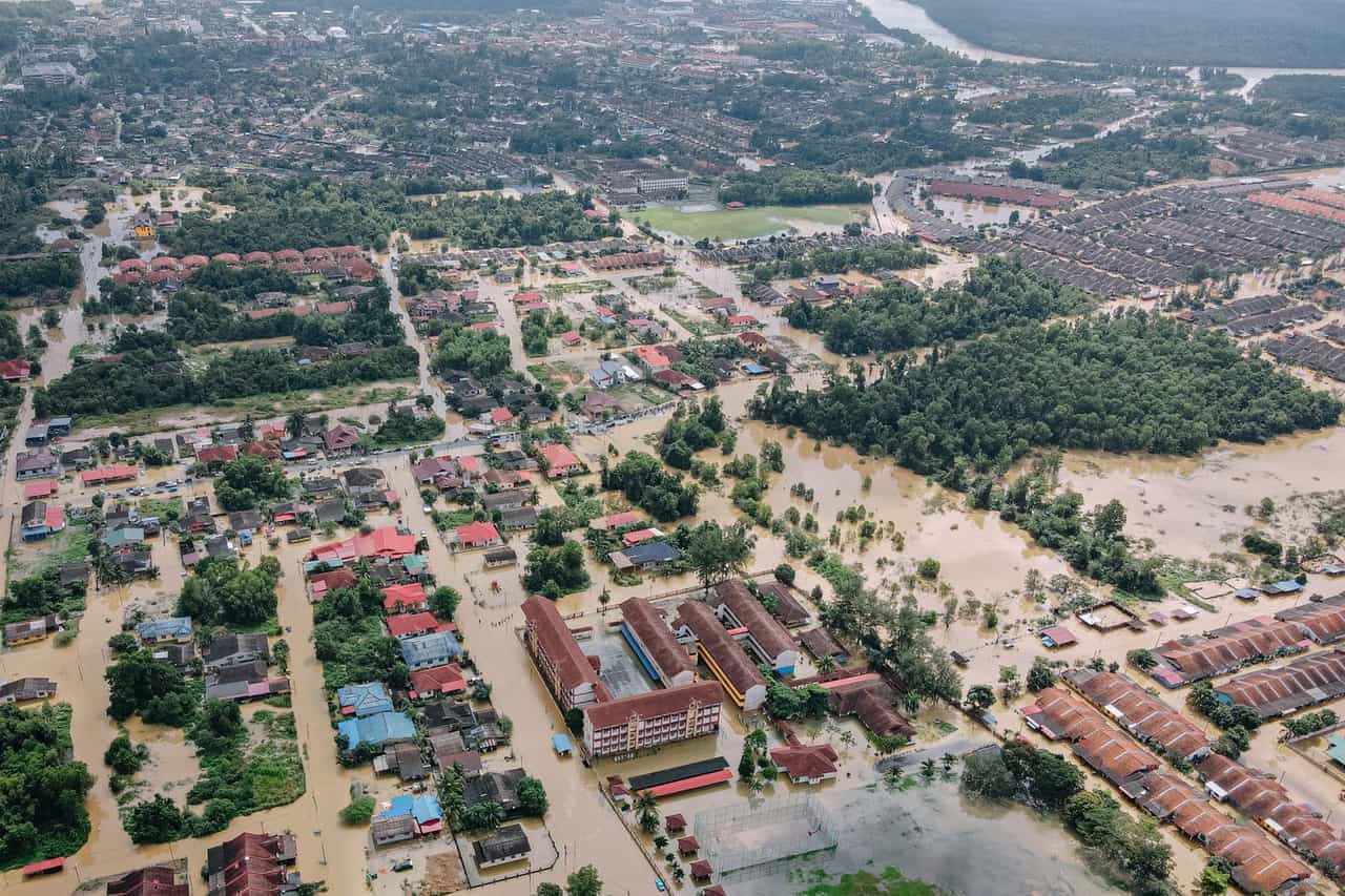 Water damage restoration Tyler TX: Flooded town with residential buildings and trees