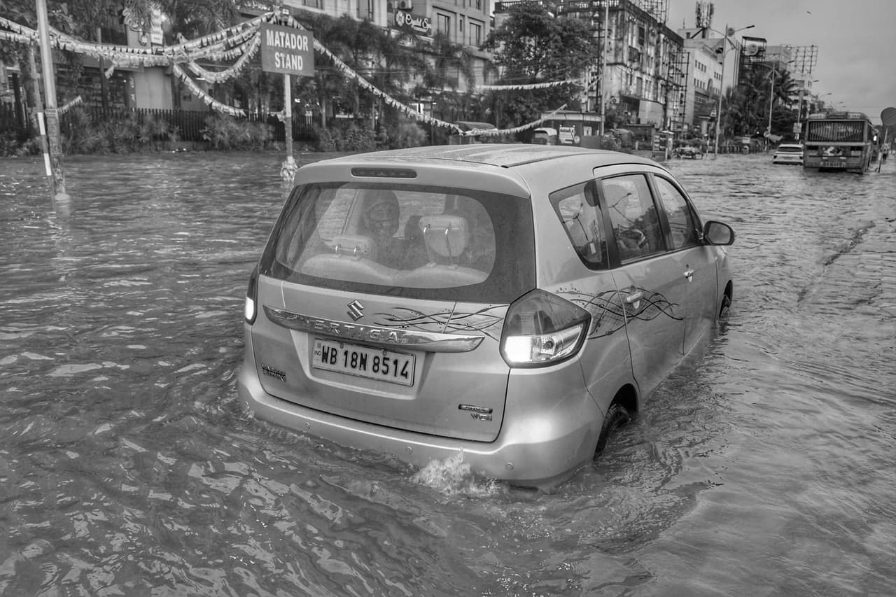 Water damage restoration Wichita KS: A car driving on a flooded street