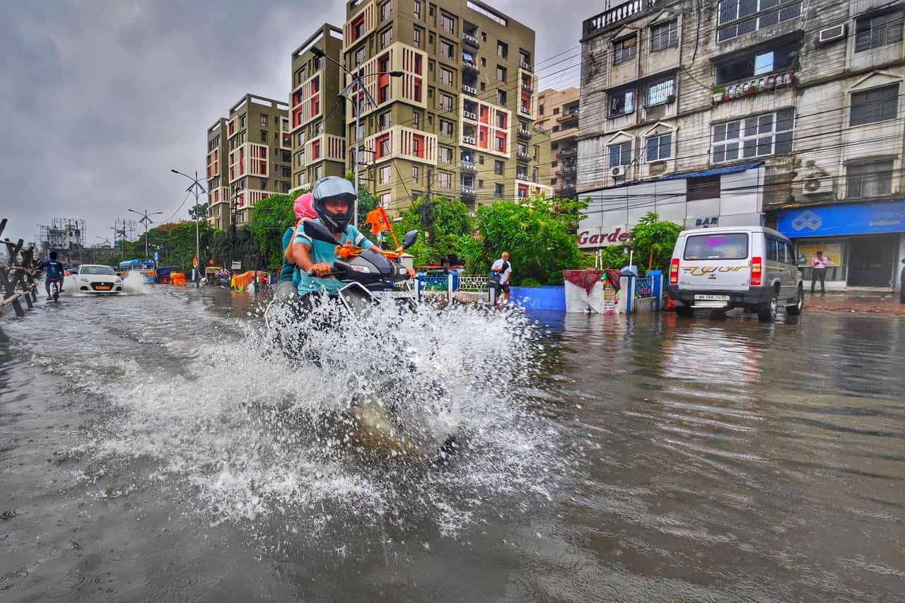Water damage restoration Yonkers NY: Motorbike rides through flooded street