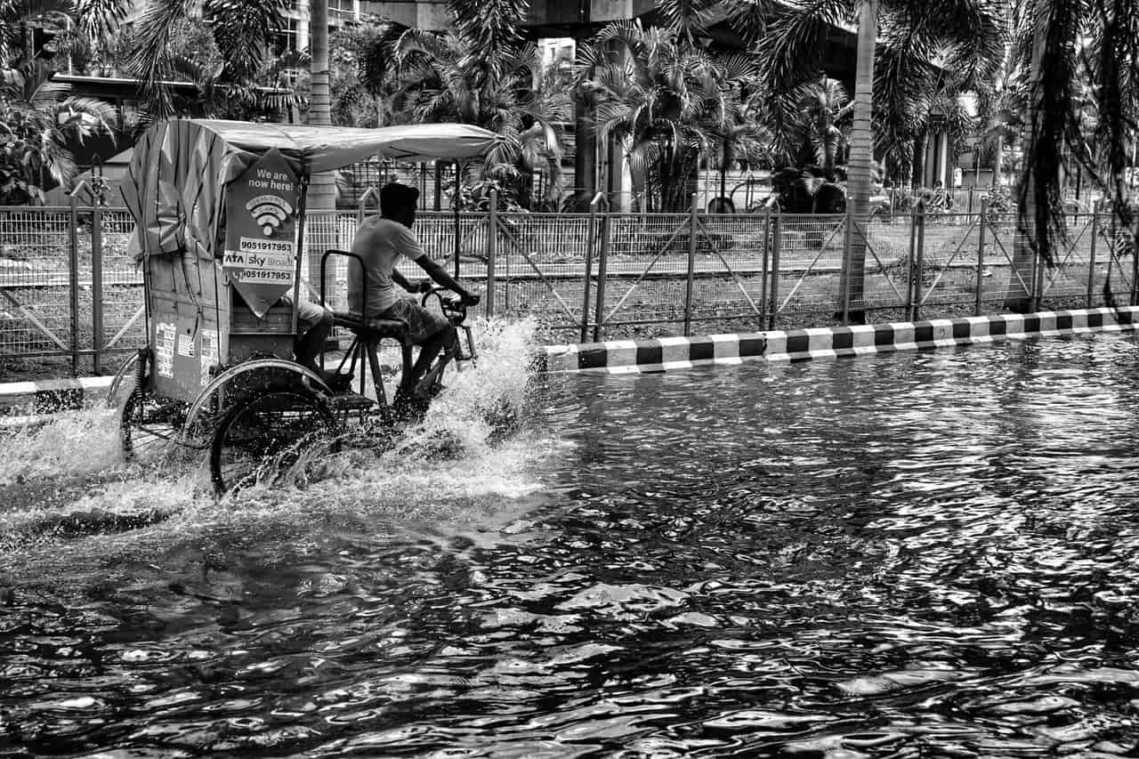 Water damage restoration Yuma AZ: Man riding rickshaw during flood